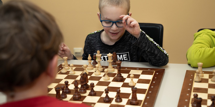 Tijdens de Denksportclub zijn kinderen een potje aan het schaken